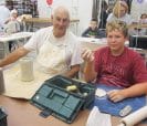 Grandfather and grandson in ceramics class.