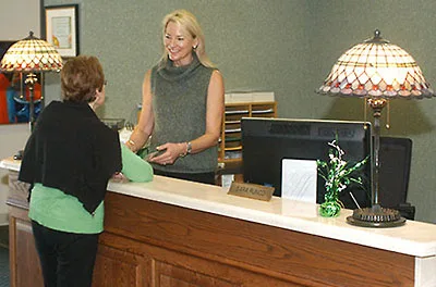 Administrator helping a women.